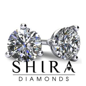 A pair of diamond stud earrings with the words shura a.