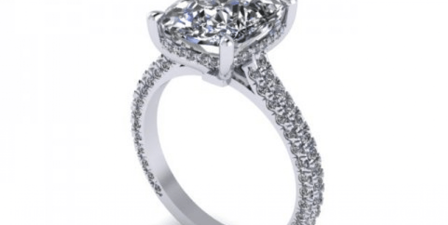 A white gold engagement ring with a round diamond center