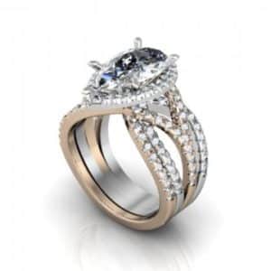 A white and gold ring with a pear shaped diamond