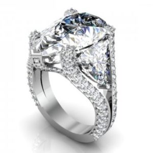 A ring with a cushion cut diamond surrounded by diamonds