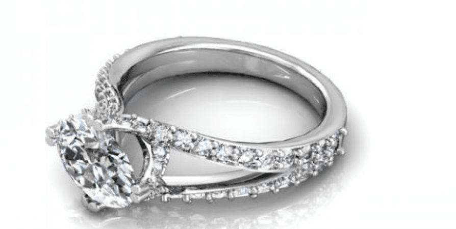 A white gold engagement ring with an oval cut diamond.