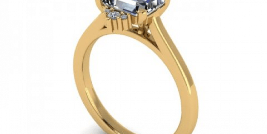 A yellow gold engagement ring with a blue topaz stone.