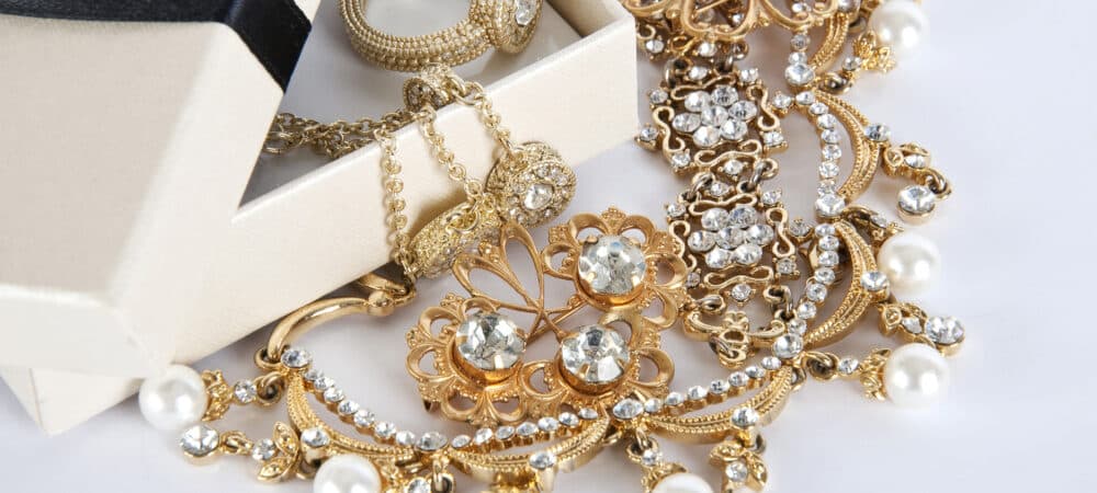 Box with Jewelry on a white background. Jewel. Pearl. Gold ring, and diamonds - Shira Diamonds