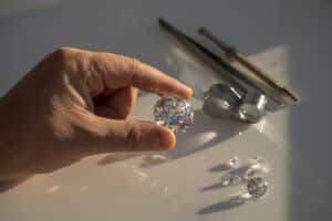 Jeweller hand holding diamonds - Shira Diamonds